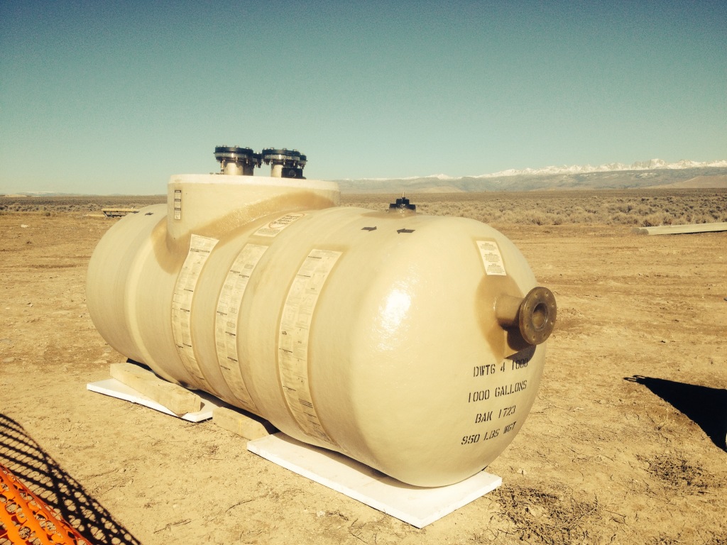 Underground double-wall Containment Solutions tank being installed for waste oil storage in Wyoming
