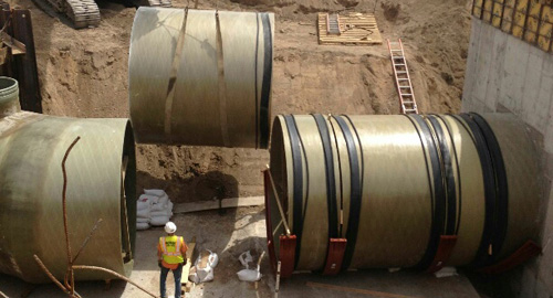 Twelve foot diameter Belco fiberglass pipe being installed in Denver Water Treatment Plant.