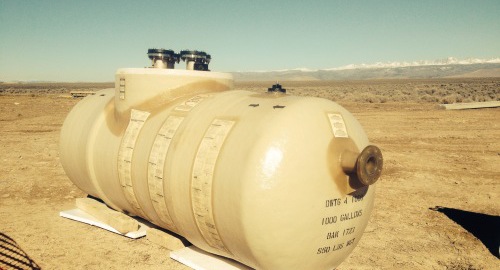 Underground double-wall Containment Solutions tank being installed for waste oil storage in Wyoming